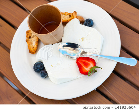 Mato cheese served with honey and berries Mato cheese served with honey and berries 141926604