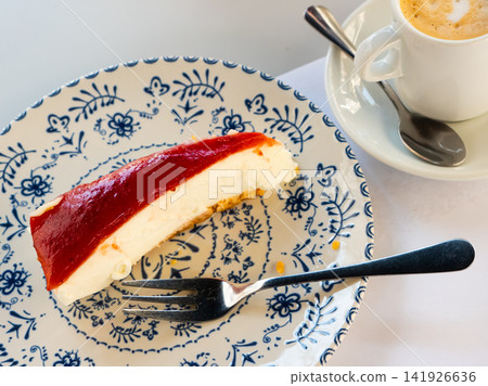 Raspberry cheesecake on saucer with berry topping Raspberry cheesecake on saucer with berry topping 141926636