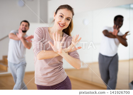 Young woman learning dynamic dances in choreography class Young woman learning dynamic dances in choreography class 141926700