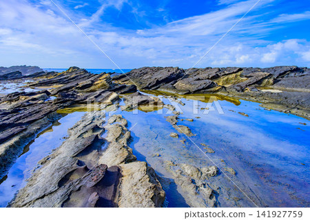 On a clear summer morning, the large tidal pool at Hinadan on Jogashima Island acts as a mirror, reflecting the blue sky with floating clouds. On a clear summer morning, the large tidal pool at Hinadan on Jogashima Island acts as a mirror, reflecting the blue sky with floating clouds. 141927759