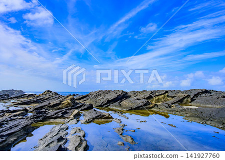On a clear summer morning, the large tidal pool at Hinadan on Jogashima Island acts as a mirror, reflecting the blue sky with floating clouds. On a clear summer morning, the large tidal pool at Hinadan on Jogashima Island acts as a mirror, reflecting the blue sky with floating clouds. 141927760