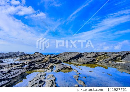 On a clear summer morning, the large tidal pool at Hinadan on Jogashima Island acts as a mirror, reflecting the blue sky with floating clouds. On a clear summer morning, the large tidal pool at Hinadan on Jogashima Island acts as a mirror, reflecting the blue sky with floating clouds. 141927761