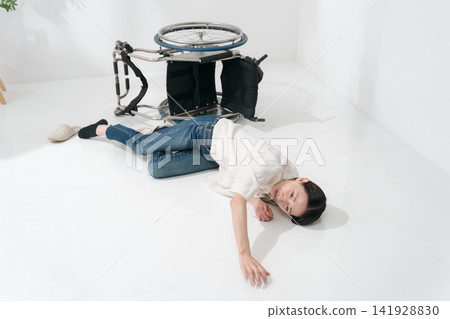 A woman who fell out of her wheelchair A woman who fell out of her wheelchair 141928830