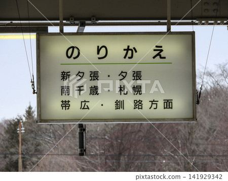 A transfer information sign on the station platform and a winter landscape. A transfer information sign on the station platform and a winter landscape. 141929342