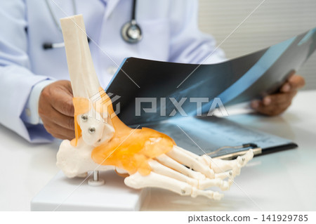 Doctor examining foot ankle  joint bone radiography xray film. 141929785