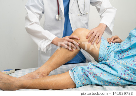 Doctor checking Asian elderly woman patient knee replacement surgery in hospital. Doctor checking Asian elderly woman patient knee replacement surgery in hospital. 141929788