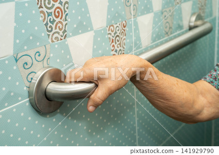 Asian elderly woman patient use toilet bathroom handle security in nursing hospital, healthy strong medical. Asian elderly woman patient use toilet bathroom handle security in nursing hospital, healthy strong medical. 141929790