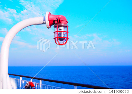 A view from a ship sailing across a blue sky and the vast ocean. A view from a ship sailing across a blue sky and the vast ocean. 141930053