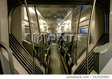 Empty modern train passenger carriage interior with seats and aisle Empty modern train passenger carriage interior with seats and aisle 141930903