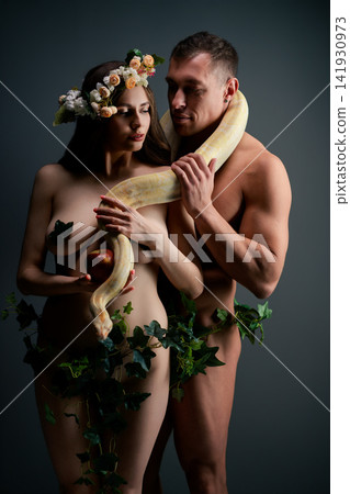 Nude couple with snake and apple in Eden inspired pose Nude couple with snake and apple in Eden inspired pose 141930973