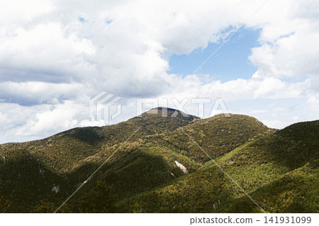 Green mountain range and cloudy sky Green mountain range and cloudy sky 141931099