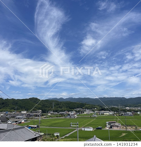 A tranquil Japanese rural landscape with a clear blue sky and dynamic cirrus clouds. A tranquil Japanese rural landscape with a clear blue sky and dynamic cirrus clouds. 141931234
