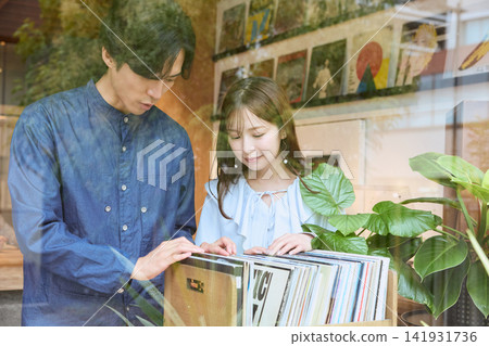 A couple choosing records together at a record shop A couple choosing records together at a record shop 141931736