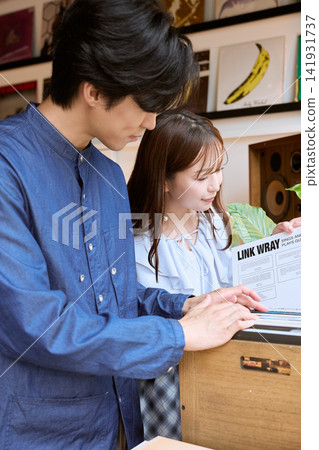A young couple choosing LP records together at a record shop. A young couple choosing LP records together at a record shop. 141931737