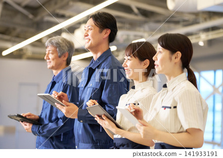 Four field staff members (two men and two women) learn using tablets. Four field staff members (two men and two women) learn using tablets. 141933191