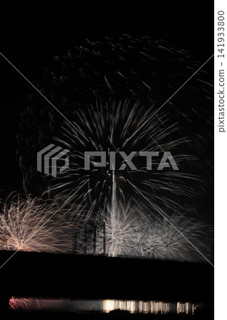 The trails of light from fireworks illuminating the summer night sky The trails of light from fireworks illuminating the summer night sky 141933800