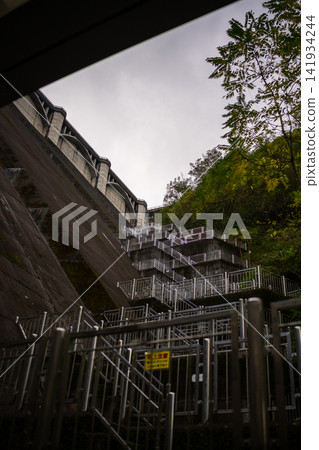 Staircases adorning the slopes of a massive dam Staircases adorning the slopes of a massive dam 141934244