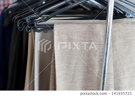 Summer slacks hanging on a hanger - Men's fashion Summer slacks hanging on a hanger - Men's fashion 141935725