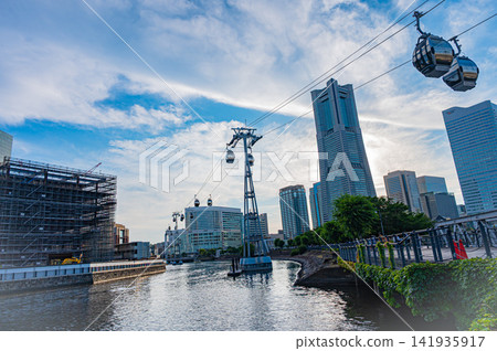 Summer in Yokohama's Minato Mirai district under a clear blue sky, showcasing the dynamic landscape of the waterfront and the city. Summer in Yokohama's Minato Mirai district under a clear blue sky, showcasing the dynamic landscape of the waterfront and the city. 141935917
