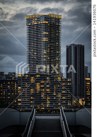 A glittering high-rise apartment building and city night view from the Toyosu waterfront on a summer night. A glittering high-rise apartment building and city night view from the Toyosu waterfront on a summer night. 141936076