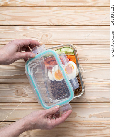 Opening reusable lunch box homemade prepared Opening reusable lunch box homemade prepared 141936125
