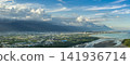 Aerial view of Hualien city, highlighting urban growth and Aerial view of Hualien city, highlighting urban growth and beautiful mountains and clouds 141936714