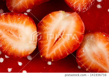 Sliced ripe strawberries on strawberry cake surface Sliced ripe strawberries on strawberry cake surface 141936738