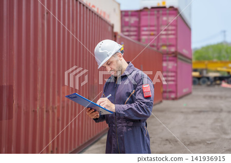 Cargo worker inspecting shipping containers at port for logistics management. Cargo worker inspecting shipping containers at port for logistics management. 141936915