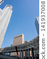 A panoramic view of the Tokyo Metropolitan Government Building No. 1, towering against the clear blue summer sky. 141937008