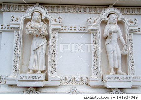 A white marble sculpture of a Hindu saint in the temple. Oldest temple in India. Beautiful sculpture of ancient India 13th century. Wall mounting background. Wall poster. A white marble sculpture of a Hindu saint in the temple. Oldest temple in India. Beautiful sculpture of ancient India 13th century. Wall mounting background. Wall poster. 141937049