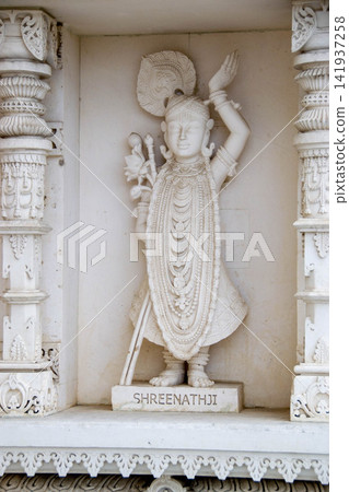 A white marble sculpture of a Hindu saint in the temple. Oldest temple in India. Beautiful sculpture of ancient India 13th century. Wall mounting background. Wall poster.  141937258