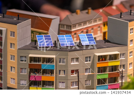 Solar panels installed on rooftop of colorful miniature apartment building model Solar panels installed on rooftop of colorful miniature apartment building model 141937434