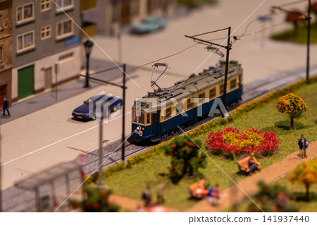 Tilt shift view of miniature tram running through detailed urban diorama Tilt shift view of miniature tram running through detailed urban diorama 141937440