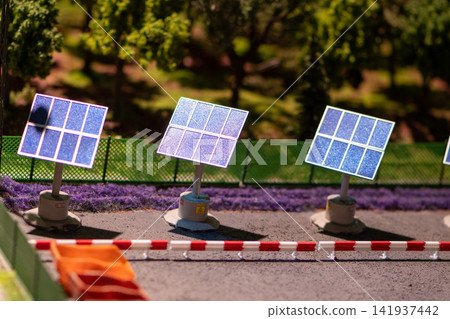 Miniature solar panels beside roadway in a detailed outdoor model landscape Miniature solar panels beside roadway in a detailed outdoor model landscape 141937442