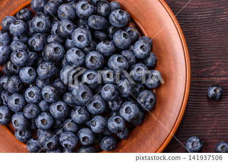 Fresh, ripe, and juicy wild blueberries as an ingredient for vegetarian dishes Fresh, ripe, and juicy wild blueberries as an ingredient for vegetarian dishes 141937506