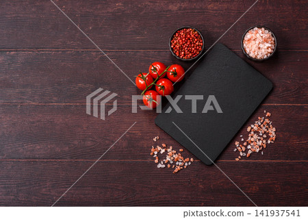 An empty black slate kitchen board for food preparation. An empty slate board serving An empty black slate kitchen board for food preparation. An empty slate board serving 141937541