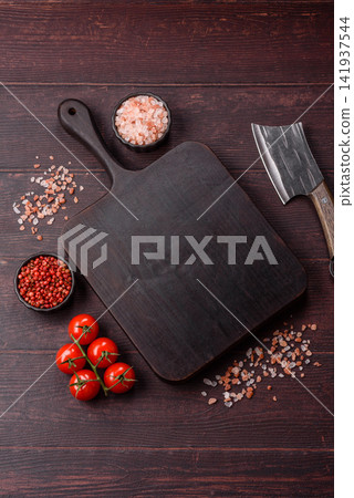 A square wooden cutting board for home food preparation. A wooden cutting board 141937544