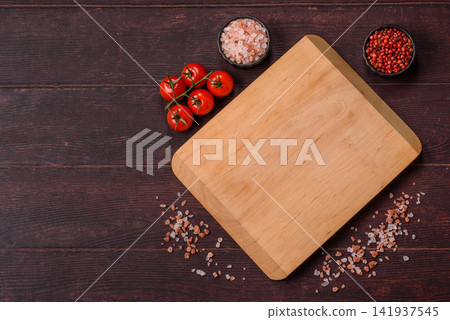 A square wooden cutting board for home food preparation. A wooden cutting board 141937545