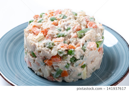 Traditional Russian Salad with Tuna and Vegetables isolated on white background Traditional Russian Salad with Tuna and Vegetables isolated on white background 141937617