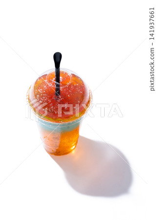 Orange Slush Drink in Plastic Cup isolated on white background. Orange Slush Drink in Plastic Cup isolated on white background. 141937661