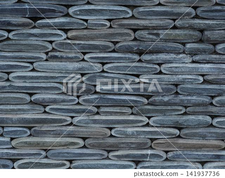 Texture of a fence made of decorative stonework made of gray sea pebbles Texture of a fence made of decorative stonework made of gray sea pebbles 141937736