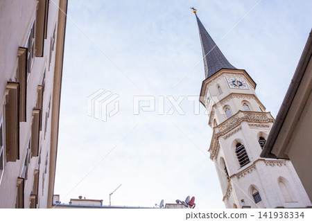 High Tower of St Michael Church in Vienna with a Clock on the Facade under a Bright Daytime Sky High Tower of St Michael Church in Vienna with a Clock on the Facade under a Bright Daytime Sky 141938334