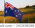 Australian flag waving against sunset field sky 141938588