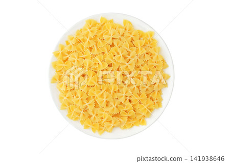 Pasta farfalle on ceramic plate isolated on white background. Top view. Various of uncooked pasta. Delicious with light vegetable, cream or tomato sauces, as well as in cold salads. Pasta farfalle on ceramic plate isolated on white background. Top view. Various of uncooked pasta. Delicious with light vegetable, cream or tomato sauces, as well as in cold salads. 141938646
