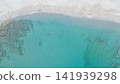 Aerial top view of turquoise sea water with small waves washing sandy beach background Libyan sea Crete island Greece travel destination concept photo 141939298