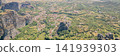 Aerial panoramic view of Kastraki village nestled between massive Meteora rock formations and green valley near Kalabaka Thessaly Greece travel stock photo 141939303