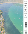 Aerial view of Nidri bay with sailboat yachts anchored in calm turquoise sea water surrounded by green hills Nydri town Lefkada island Greece travel stock photo 141939312