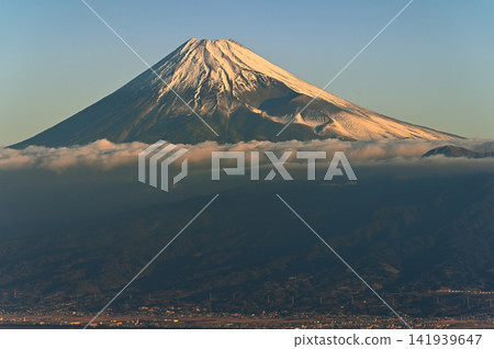 Mount Fuji bathed in the morning sun, viewed from Kinkanzan Mountain on the Izu Mountain Ridge Trail in the Izu Peninsula. Mount Fuji bathed in the morning sun, viewed from Kinkanzan Mountain on the Izu Mountain Ridge Trail in the Izu Peninsula. 141939647