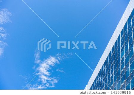 Glass Facade Office Building Under Blue Sky for Modern Architecture Corporate Vision and Real Estate Investment Background, Low Angle Perspective Photo with Copyspace Glass Facade Office Building Under Blue Sky for Modern Architecture Corporate Vision and Real Estate Investment Background, Low Angle Perspective Photo with Copyspace 141939916