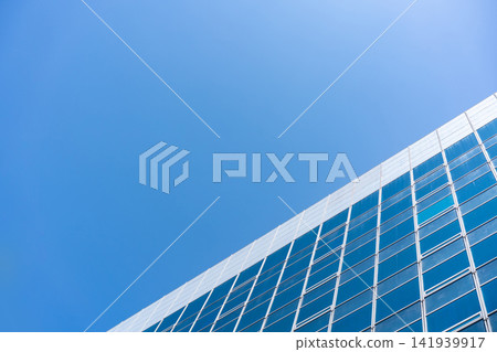 Glass Facade Office Building Under Blue Sky for Modern Architecture Corporate Vision and Real Estate Investment Background, Low Angle Perspective Photo with Copyspace Glass Facade Office Building Under Blue Sky for Modern Architecture Corporate Vision and Real Estate Investment Background, Low Angle Perspective Photo with Copyspace 141939917